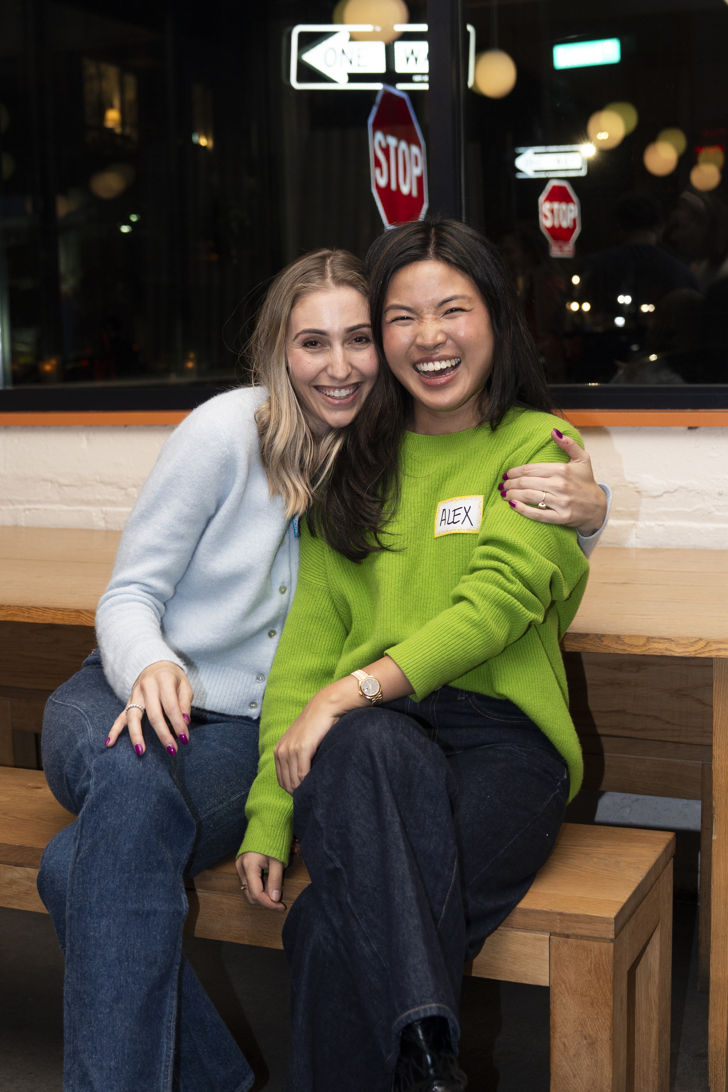 Two women laughing and hugging at Anti-Networking NYC