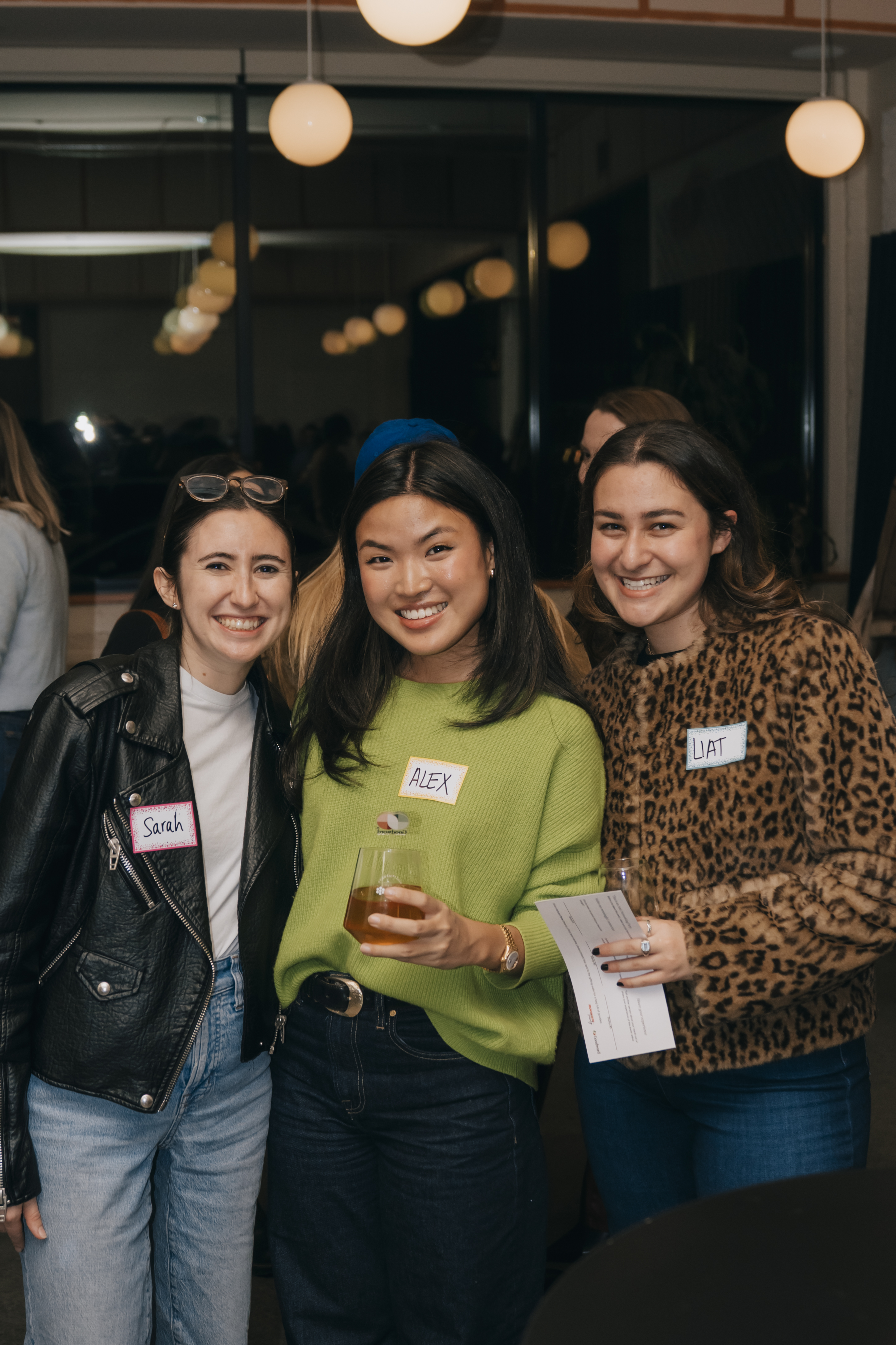 Three women posing with drinks at Anti-Networking NYC