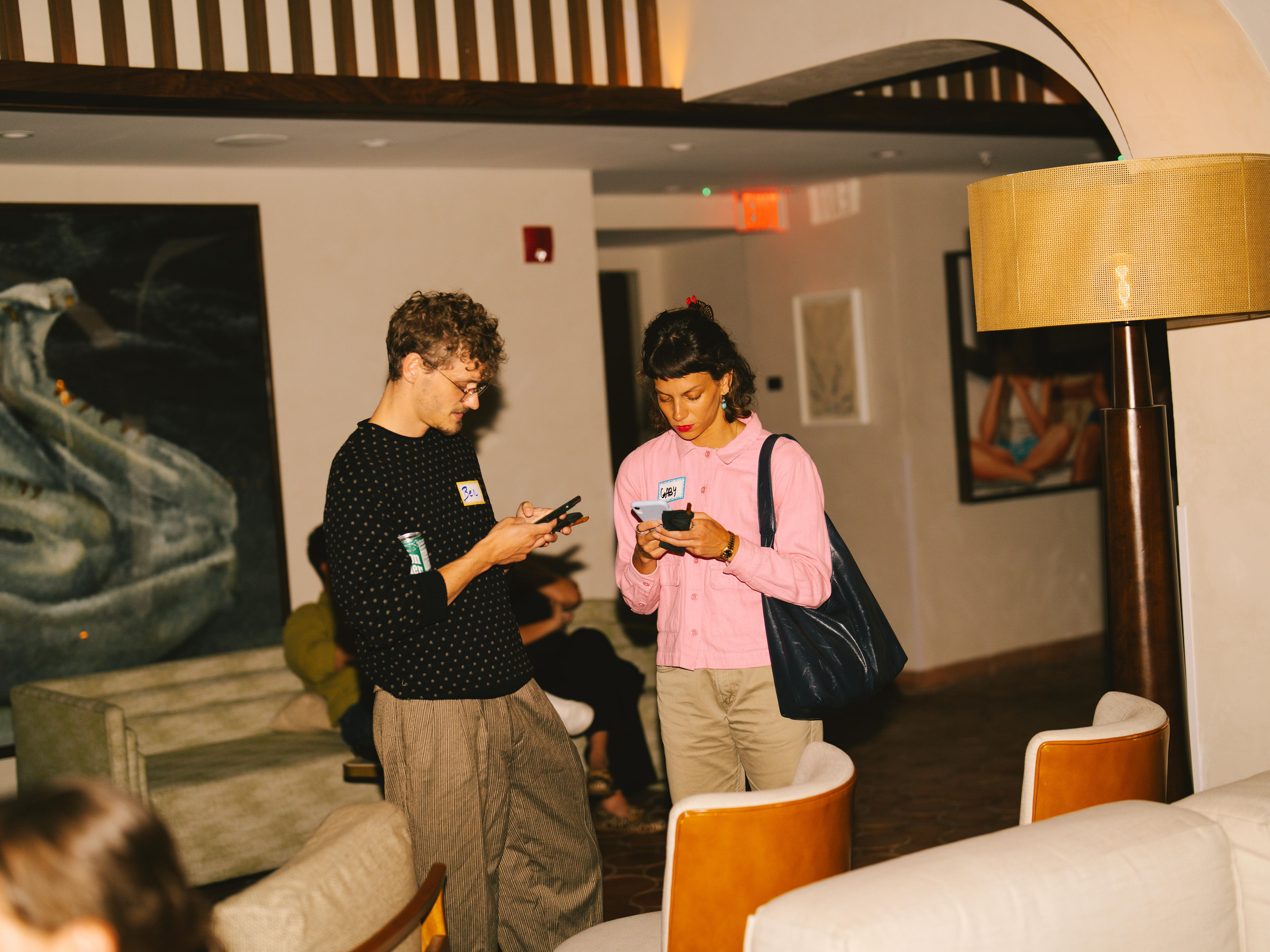 Two guests exchanging numbers at Anti-Networking Miami