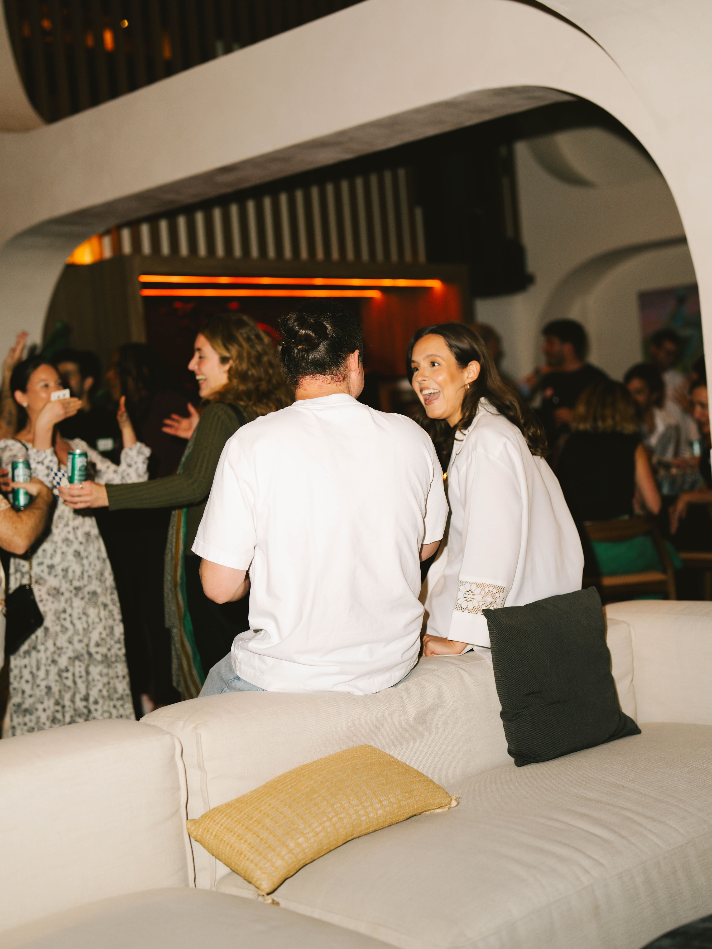 Guest laughing on the couch at Anti-Networking Miami