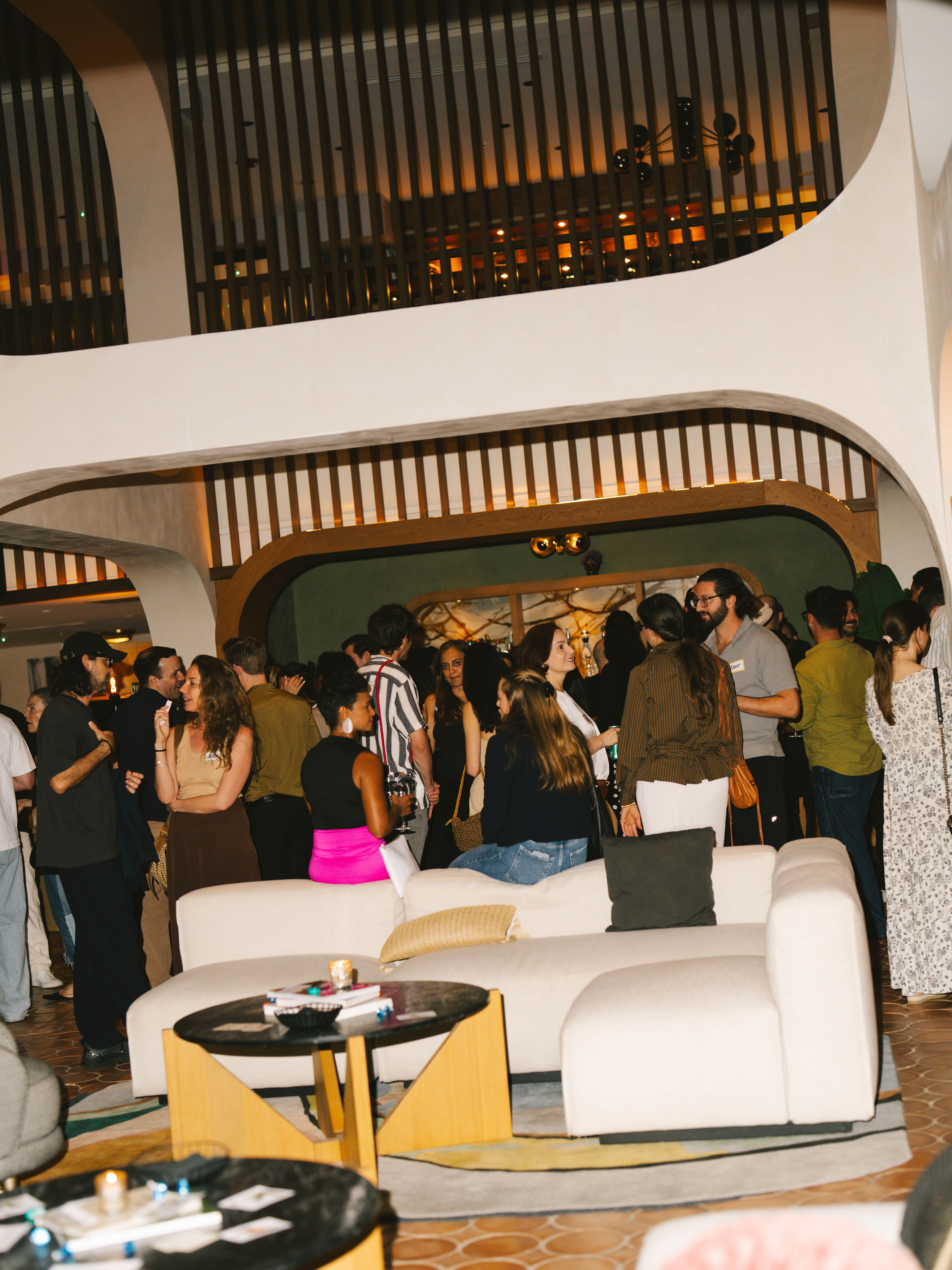 Crowd mingling under the arches at Anti-Networking Miami
